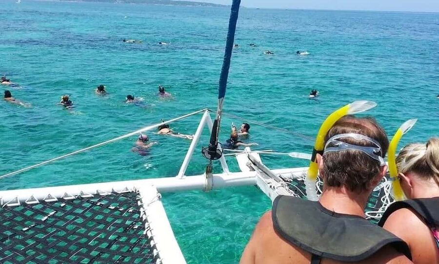 From Falmouth/Ocho Rios: Negril Beach and Catamaran Cruise - Boarding the catamaran from the water